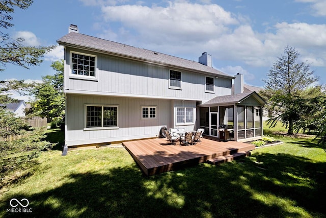 8909 Carnation Dr, Noblesville, IN 46060 - rear view of house featuring a chimney, a sunroom, a deck, and a lawn
