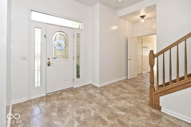 8909 Carnation Dr, Noblesville, IN 46060 - foyer entrance with plenty of natural light, stairway, and stone finish flooring