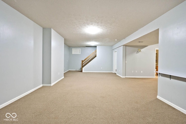 8909 Carnation Dr, Noblesville, IN 46060 - finished basement featuring a textured ceiling, carpet flooring, and stairs