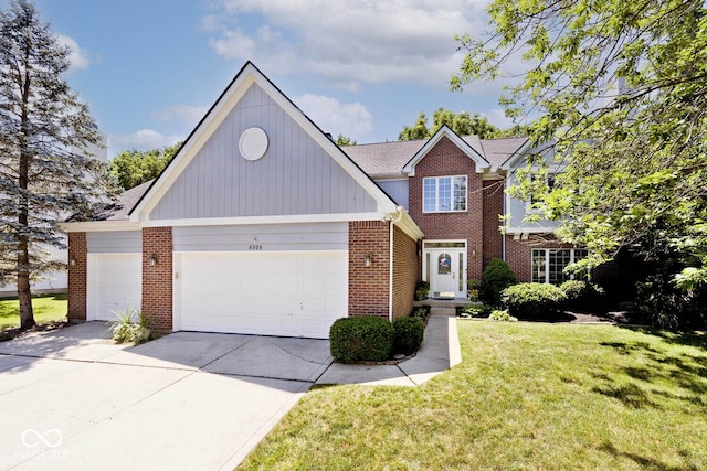 8909 Carnation Dr, Noblesville, IN 46060 - view of front facade featuring brick siding, a garage, a front lawn, and driveway