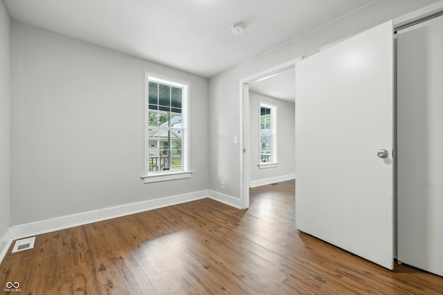 1151 S Randolph St, Indianapolis, IN 46203 - empty room with a smoke detector and wood finished floors