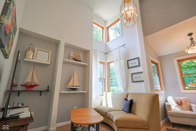 8167 Center Lake Rd, Nineveh, IN 46164 - sitting room featuring healthy amount of natural light, wood finished floors, a chandelier, a high ceiling, and built in features