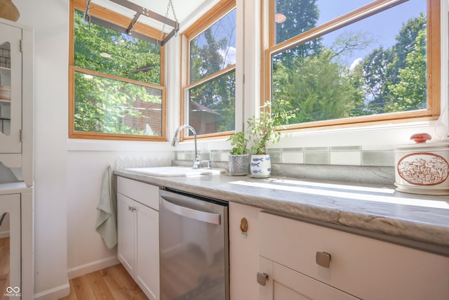 8167 Center Lake Rd, Nineveh, IN 46164 - kitchen with dishwasher, white cabinetry, light wood finished floors, and stacked washer / dryer