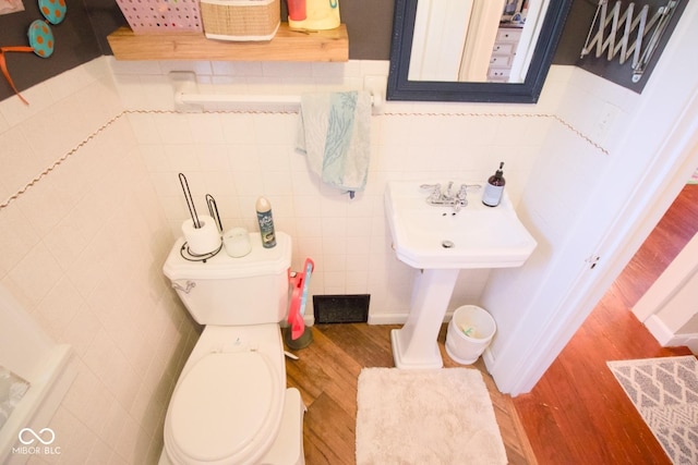 643 Harlan St, Plainfield, IN 46168 - half bath featuring wood finished floors and tile walls