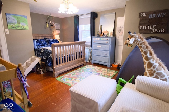 643 Harlan St, Plainfield, IN 46168 - bedroom with wood finished floors and a chandelier