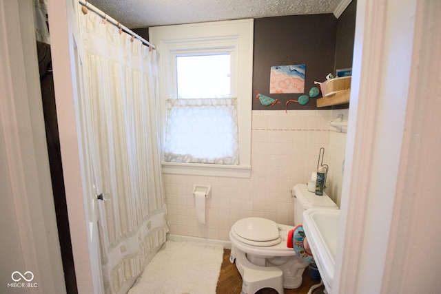643 Harlan St, Plainfield, IN 46168 - bathroom with tile walls, a textured ceiling, and a shower with shower curtain