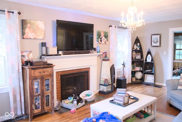643 Harlan St, Plainfield, IN 46168 - living area featuring a chandelier, wood finished floors, and a brick fireplace