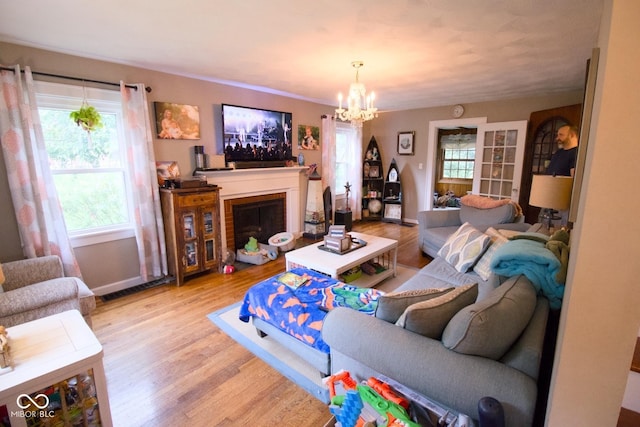 643 Harlan St, Plainfield, IN 46168 - living room featuring wood finished floors, a chandelier, and a fireplace