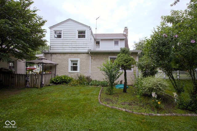 643 Harlan St, Plainfield, IN 46168 - rear view of property with a gazebo, stone siding, and a chimney
