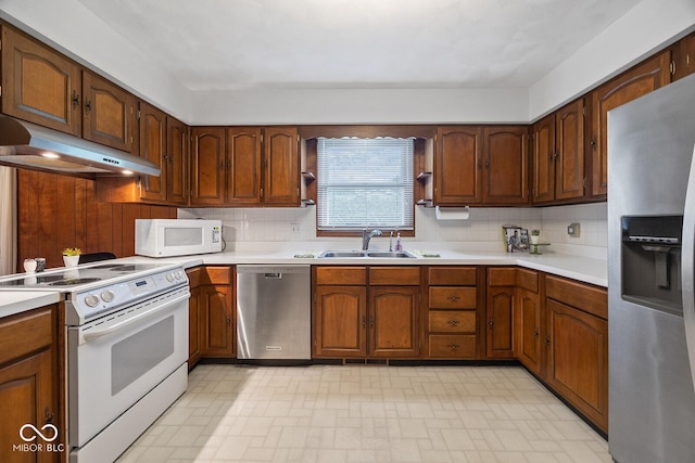 3620 Winter St, Lafayette, IN 47909 - kitchen featuring appliances with stainless steel finishes, under cabinet range hood, light countertops, and decorative backsplash