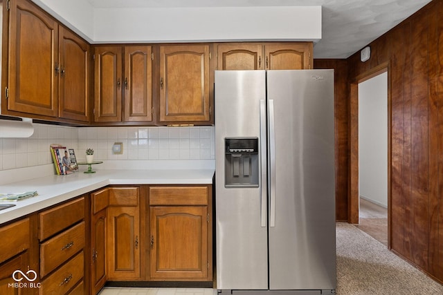 3620 Winter St, Lafayette, IN 47909 - kitchen with stainless steel refrigerator with ice dispenser, brown cabinetry, light countertops, and decorative backsplash