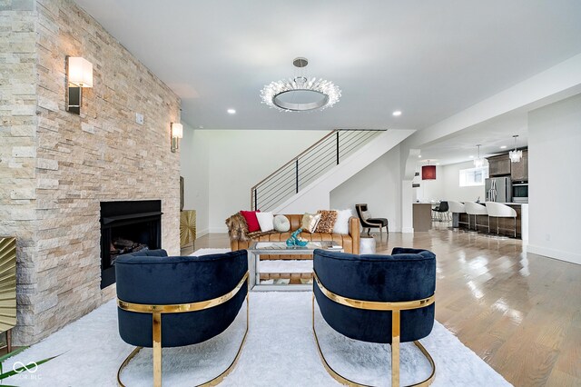 2130 Brookside Pkwy N Drive, Indianapolis, IN 46201 - living room with stairway, wood finished floors, a stone fireplace, and recessed lighting