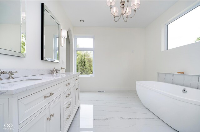 2130 Brookside Pkwy N Drive, Indianapolis, IN 46201 - bathroom featuring marble look tiles, a freestanding bath, and double vanity