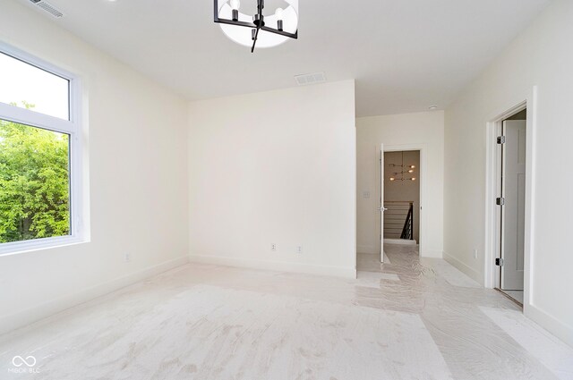 2130 Brookside Pkwy N Drive, Indianapolis, IN 46201 - spare room with a chandelier and baseboards