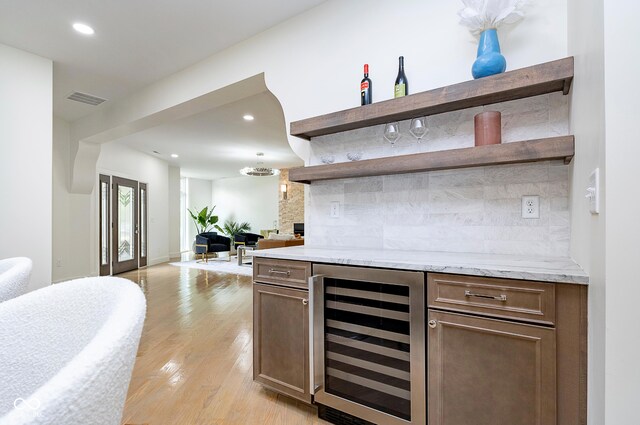2130 Brookside Pkwy N Drive, Indianapolis, IN 46201 - indoor dry bar featuring beverage cooler, light wood-type flooring, tasteful backsplash, and recessed lighting
