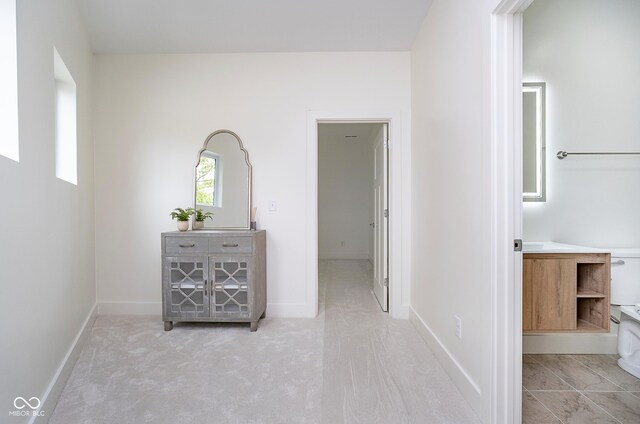 2130 Brookside Pkwy N Drive, Indianapolis, IN 46201 - corridor featuring baseboards and light carpet