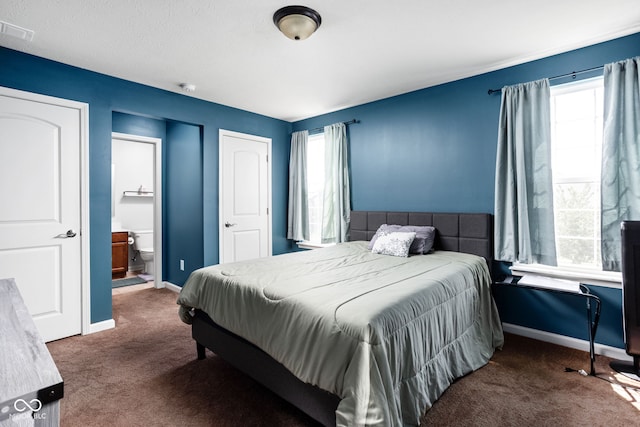 6176 Brighton Dr, Whitestown, IN 46075 - carpeted bedroom featuring multiple windows and ensuite bath
