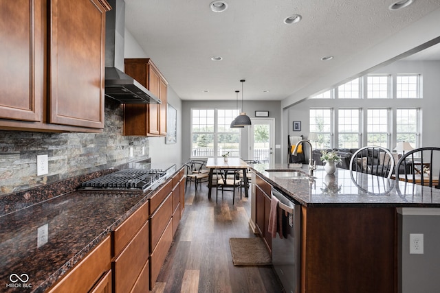 6176 Brighton Dr, Whitestown, IN 46075 - kitchen featuring wall chimney exhaust hood, stainless steel appliances, dark wood finished floors, a center island with sink, and tasteful backsplash