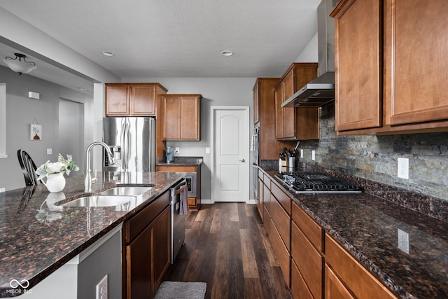 6176 Brighton Dr, Whitestown, IN 46075 - kitchen featuring appliances with stainless steel finishes, wall chimney exhaust hood, dark wood-style floors, backsplash, and brown cabinets