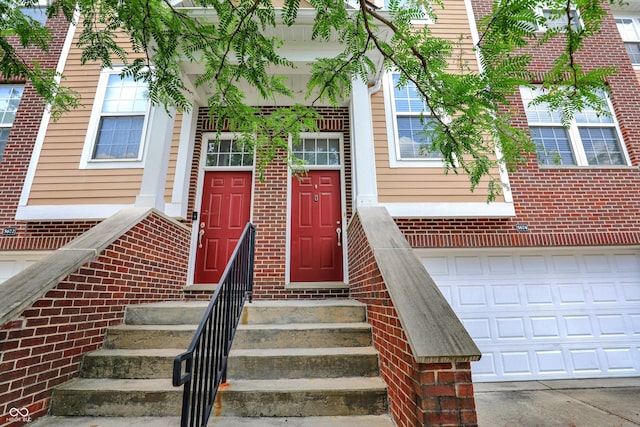 5674 Brownstone Dr, Indianapolis, IN 46220 - entrance to property with brick siding and an attached garage