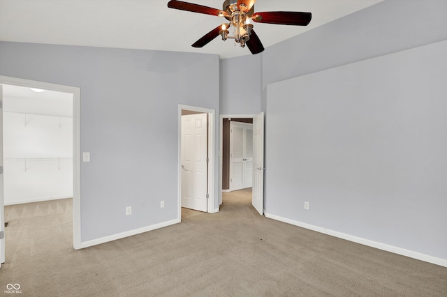 5674 Brownstone Dr, Indianapolis, IN 46220 - unfurnished bedroom featuring carpet, a walk in closet, a closet, and ceiling fan