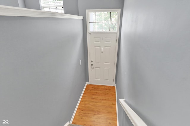 5674 Brownstone Dr, Indianapolis, IN 46220 - doorway to outside featuring light wood-style flooring and baseboards