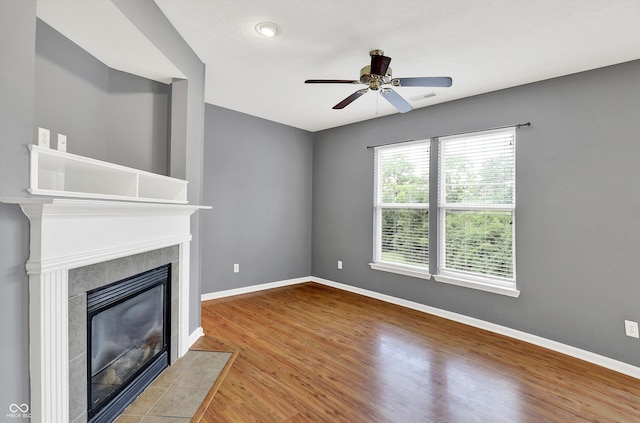 5674 Brownstone Dr, Indianapolis, IN 46220 - unfurnished living room featuring a fireplace, wood finished floors, and ceiling fan