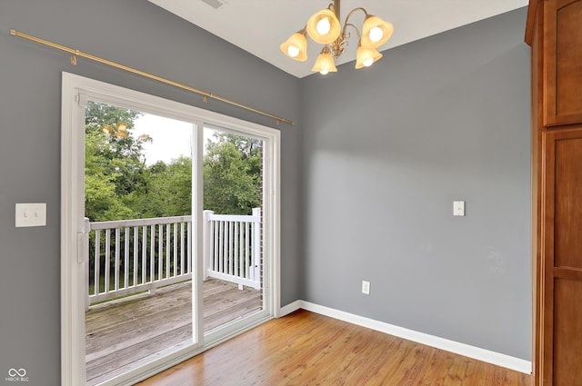 5674 Brownstone Dr, Indianapolis, IN 46220 - spare room featuring a chandelier and light wood-style floors