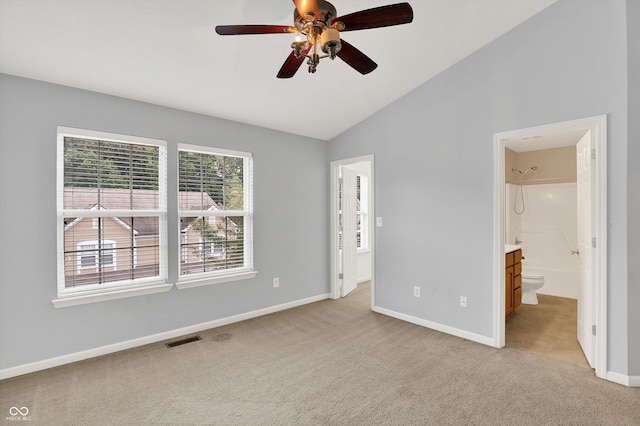 5674 Brownstone Dr, Indianapolis, IN 46220 - unfurnished bedroom with light colored carpet, vaulted ceiling, ensuite bathroom, and a ceiling fan