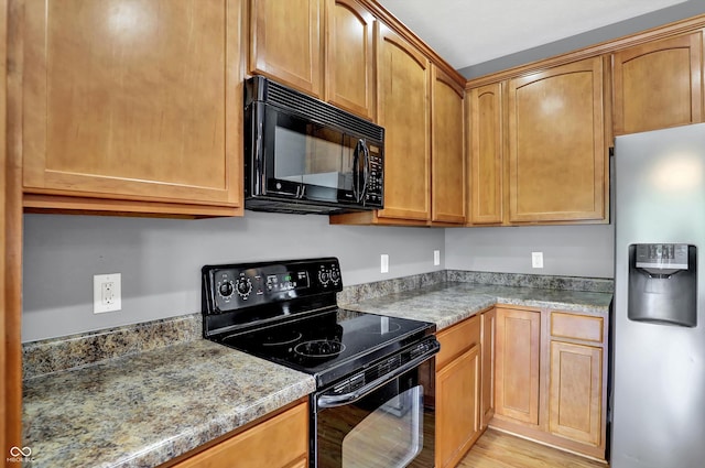 5674 Brownstone Dr, Indianapolis, IN 46220 - kitchen with black appliances, light wood finished floors, and light stone counters