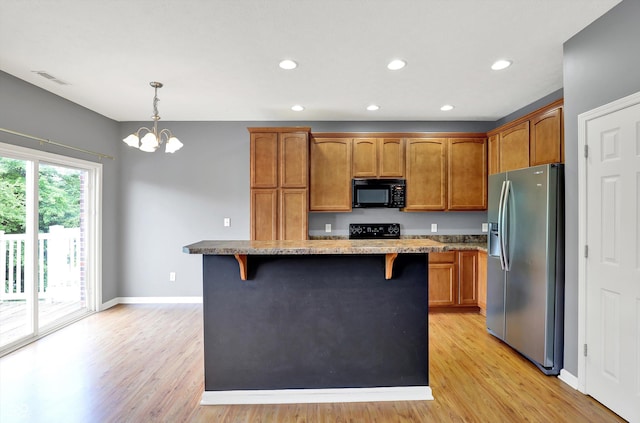 5674 Brownstone Dr, Indianapolis, IN 46220 - kitchen featuring black microwave, stainless steel fridge with ice dispenser, range with electric cooktop, a kitchen bar, and brown cabinets