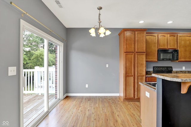 5674 Brownstone Dr, Indianapolis, IN 46220 - kitchen featuring black microwave, light wood-style flooring, a chandelier, pendant lighting, and brown cabinetry