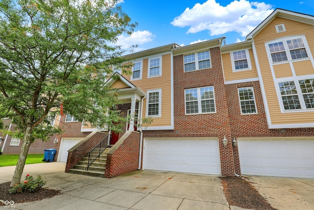 5674 Brownstone Dr, Indianapolis, IN 46220 - multi unit property with a garage, driveway, and brick siding