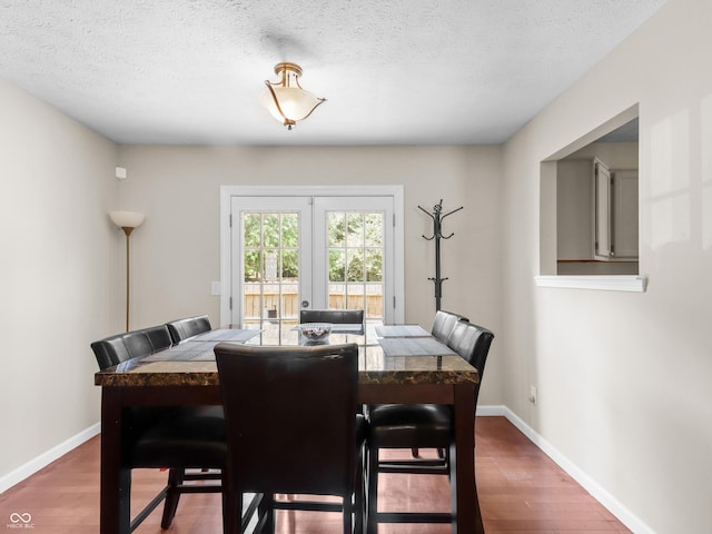 5626 Prince Woods Cir, Indianapolis, IN 46224 - dining space featuring wood finished floors, french doors, and a textured ceiling