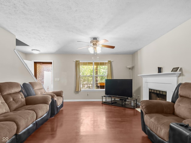 5626 Prince Woods Cir, Indianapolis, IN 46224 - living area featuring wood finished floors, ceiling fan, a fireplace, and a textured ceiling