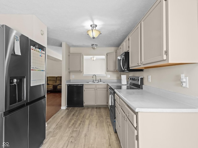 5626 Prince Woods Cir, Indianapolis, IN 46224 - kitchen with stainless steel appliances, light wood finished floors, light countertops, and a textured ceiling
