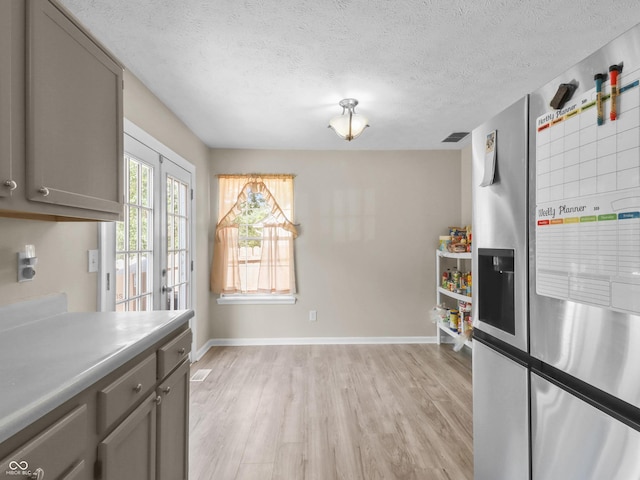 5626 Prince Woods Cir, Indianapolis, IN 46224 - kitchen featuring stainless steel fridge, gray cabinetry, light wood-type flooring, and a textured ceiling