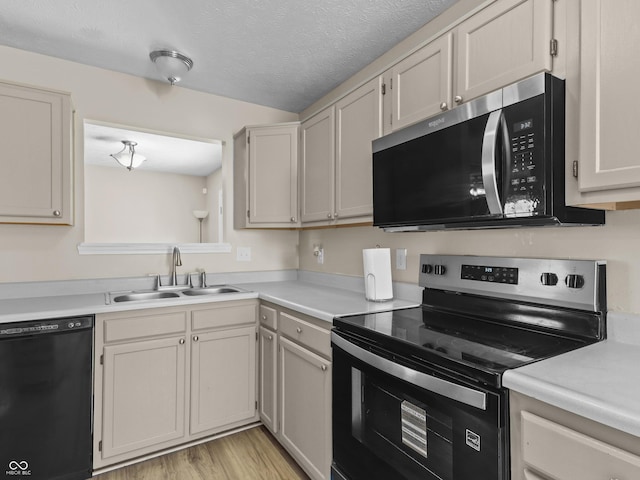 5626 Prince Woods Cir, Indianapolis, IN 46224 - kitchen featuring stainless steel appliances, light countertops, a textured ceiling, and light wood finished floors