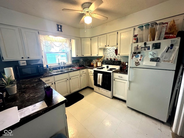 1000 Meadow Ln, Greencastle, IN 46135 - kitchen featuring white appliances, dark countertops, and a ceiling fan