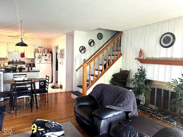 1000 Meadow Ln, Greencastle, IN 46135 - living room featuring wood finished floors, stairs, and a textured ceiling