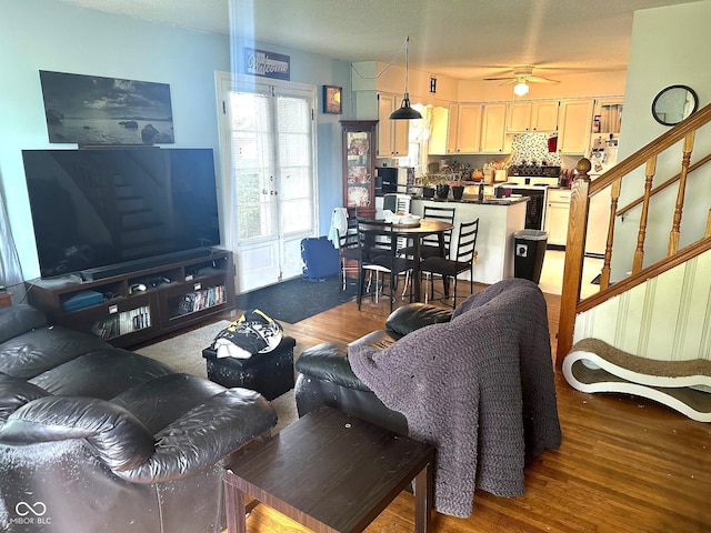 1000 Meadow Ln, Greencastle, IN 46135 - living area featuring wood finished floors, ceiling fan, and stairway