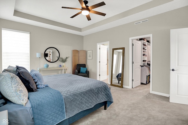 1319 Petit Verdot Dr, Westfield, IN 46074 - bedroom with a spacious closet, a tray ceiling, light carpet, and a ceiling fan