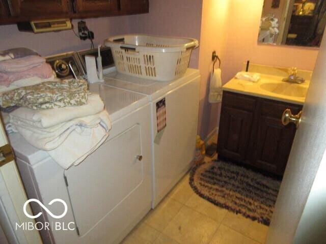 2610 Marywood Dr, Southport, IN 46227 - washroom featuring washing machine and clothes dryer, bar with sink, and light tile patterned flooring
