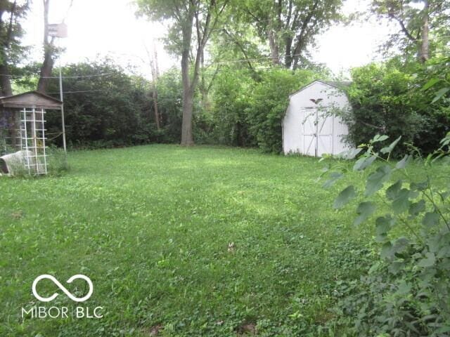 2610 Marywood Dr, Southport, IN 46227 - view of grassy yard featuring a storage unit