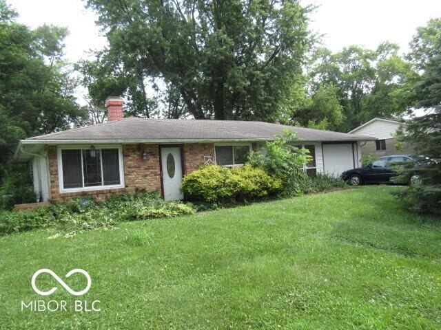 2610 Marywood Dr, Southport, IN 46227 - ranch-style home with a chimney, a garage, and a front yard