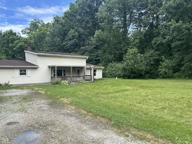 1330 Schleicher Ave, Indianapolis, IN 46229 - view of front of house with a porch, a front yard, driveway, and a chimney