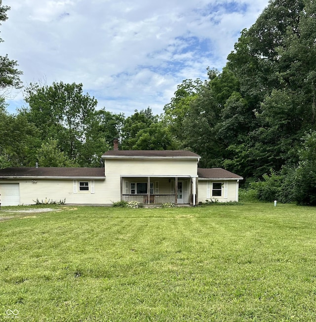 1330 Schleicher Ave, Indianapolis, IN 46229 - rear view of house featuring covered porch, a yard, and a chimney