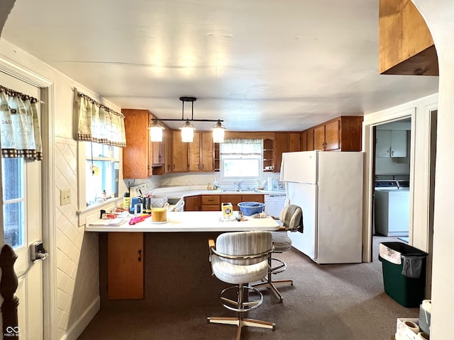 4096 N 200 W, Greenfield, IN 46140 - kitchen with white appliances, washer / clothes dryer, a peninsula, brown cabinetry, and light countertops