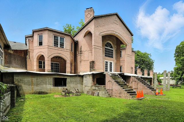 7843 E Triple Crown Ln, Camby, IN 46113 - rear view of property with stairway, brick siding, a yard, and a chimney