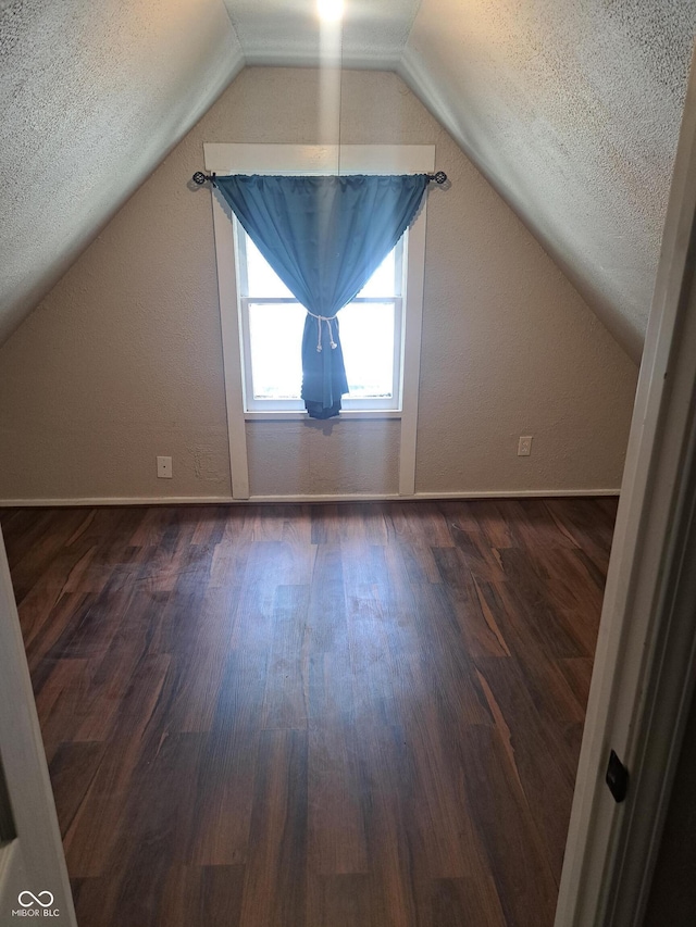 103 N Chester Ave, Indianapolis, IN 46201 - additional living space with dark wood-style flooring, vaulted ceiling, and a textured ceiling